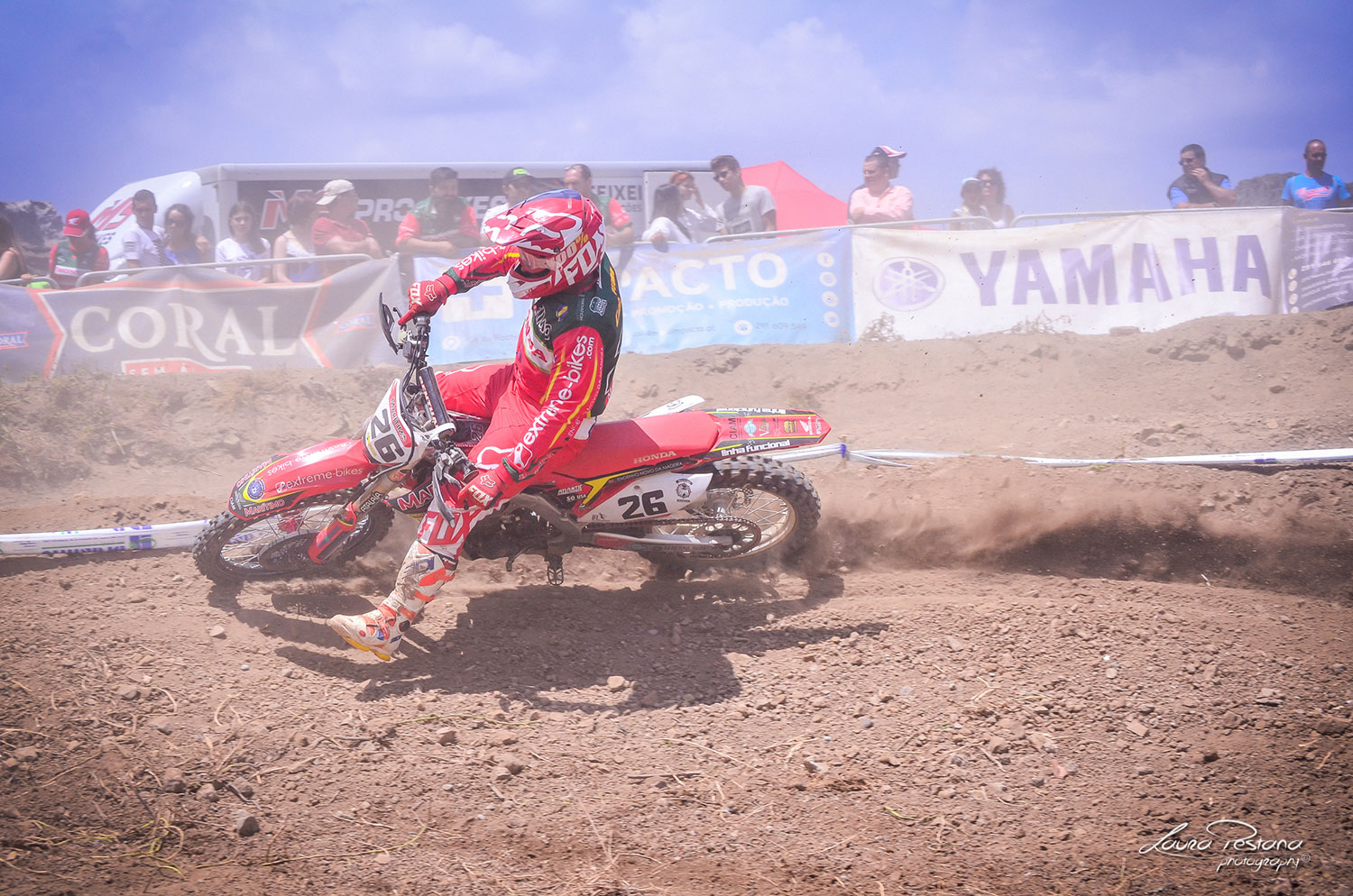 A rider making the berm on his honda crf on a motocross track